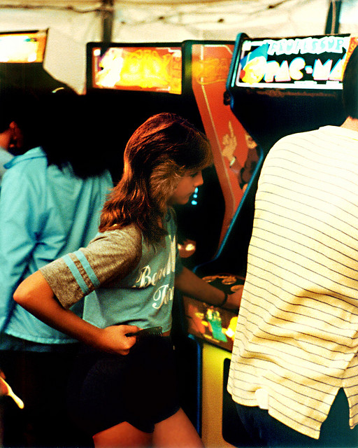 Girl playing Pac-Man in arcade in1983