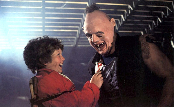 Chunk offers Sloth a Baby Ruth