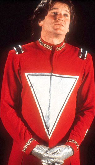 Mork in his red spacesuit reporting to Orson